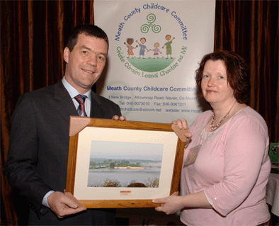 Minister for Communications and Natural Resources Noel Dempsey being presented with a picture of Newgrange by Theresa Heeney MCCC Board member